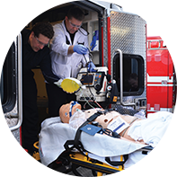 dummy in a stretcher in front of an ambulance